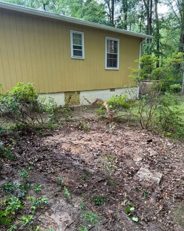 After: the shed removed, leaving a cleared patch of ground beside the house