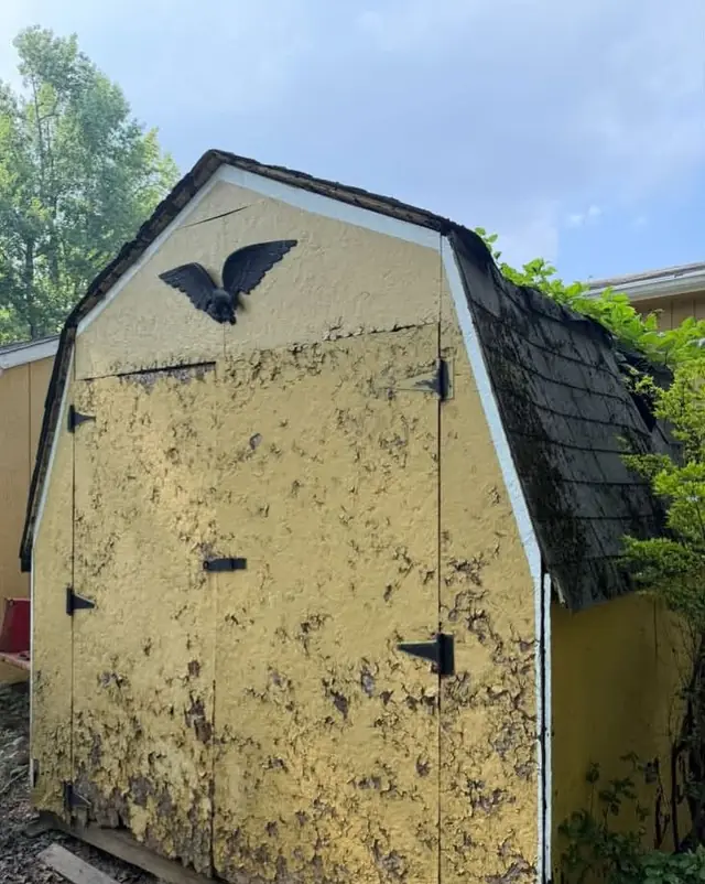 Before: an old yellow shed with peeling paint and a damaged roof