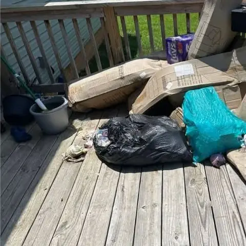 Before: a back deck covered in bags and flattened boxes
