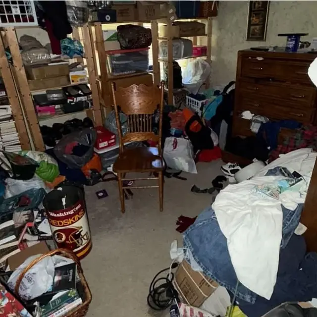 Before: a room crowded with clothes, boxes, books and bags