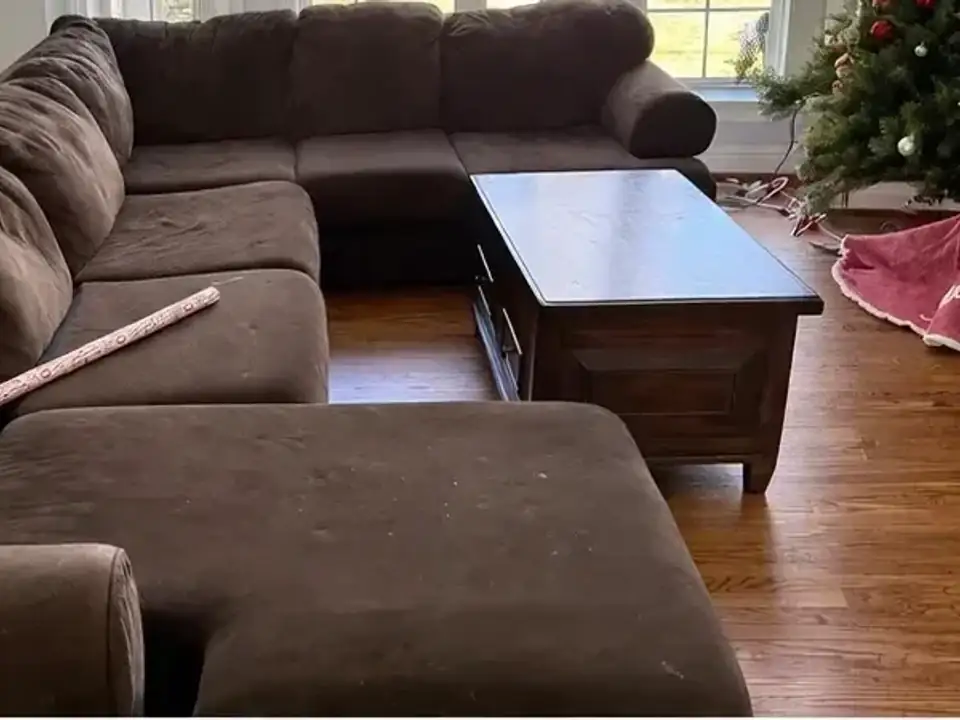 Before: a living room with a large sectional sofa and coffee table