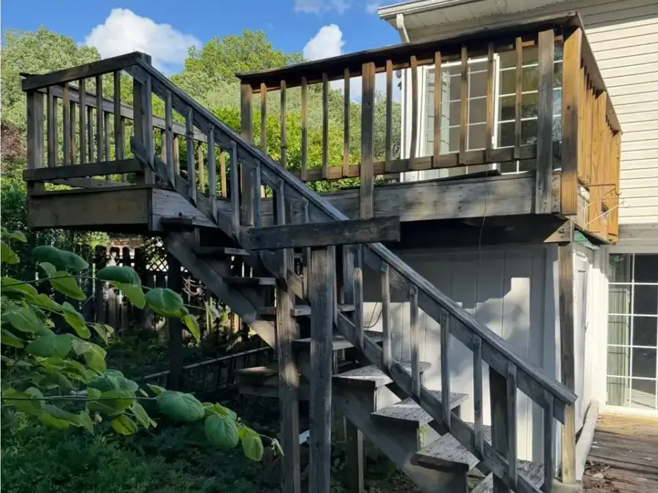 Before: an old wooden deck and stairs on the back of a house